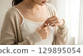 Blank camisole top worn mockup under cardigan, adjusting necklace, close-up, isolated 129895054