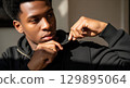 Blank black zip-up hoodie half zipped worn, isolated 129895064