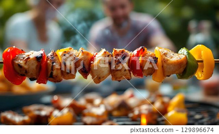 Delicious grilled vegetable skewers on a grill, symbolizing summer outdoor activities and cherished family moments 129896674
