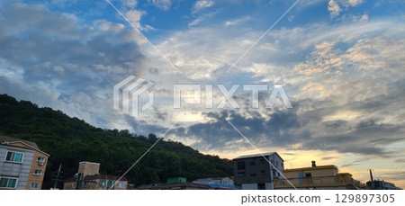 A stunning sunrise viewed from the upper floor of an apartment, showcasing a breathtaking scene of golden hues spreading across the city skyline from above. A stunning sunrise viewed from the upper floor of an apartment, showcasing a breathtaking scene of golden hues spreading across the city skyline from above. 129897305
