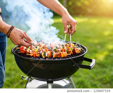 Barbecue at hand 129897334