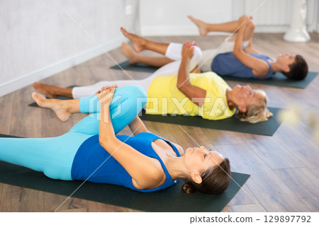 Knees To Chest Pose - Apanasana Knees To Chest Pose - Apanasana 129897792