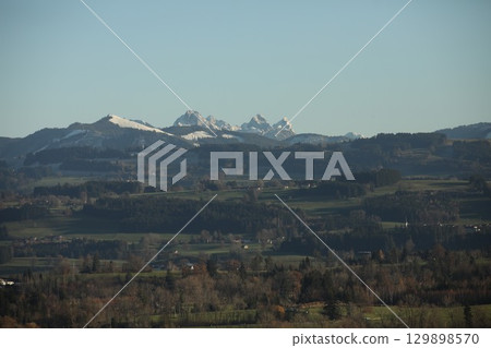 Mountain range with snow on the top and a clear blue sky Mountain range with snow on the top and a clear blue sky 129898570