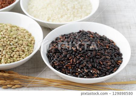 Various types of rice (green rice, black rice, white rice) on a plate 129898580