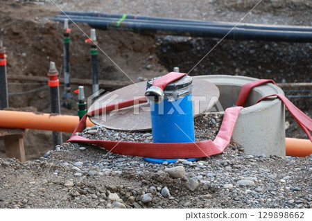 Blue pipe is tied to a red rope Blue pipe is tied to a red rope 129898662