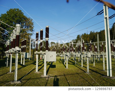 Large field of power lines with many poles and wires 129898787