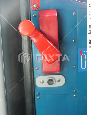 Red and white knob on a blue door Red and white knob on a blue door 129899457