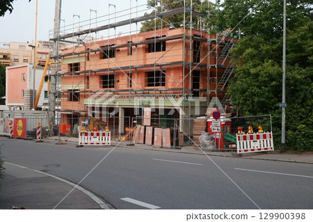 Construction site is visible on the side of a street 129900398