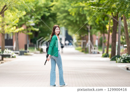 Female college student walking on university campus Female college student walking on university campus 129900416