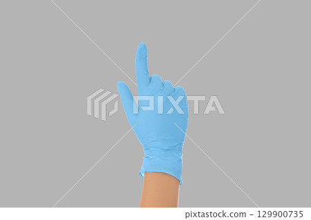 A gloved hand points upward demonstrating medical readiness. A gloved hand points upward demonstrating medical readiness. 129900735