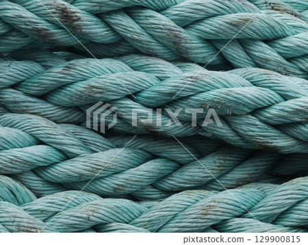 The rope is blue and has a lot of knots 129900815