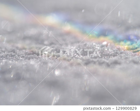 Snow covered ground with a rainbow in the sky Snow covered ground with a rainbow in the sky 129900829