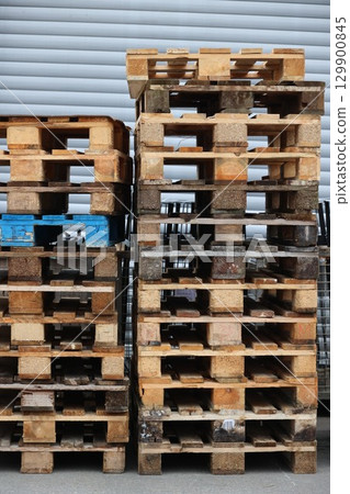 A stack of wooden pallets with blue and brown wood 129900845