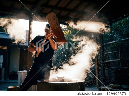 Traditional Japanese mochi pounding scene 129900873
