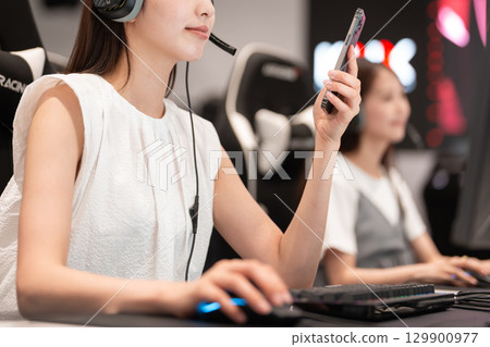 Young woman enjoying games at an e-sports tournament Young woman enjoying games at an e-sports tournament 129900977