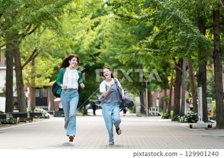 University campus female college student running 129901240
