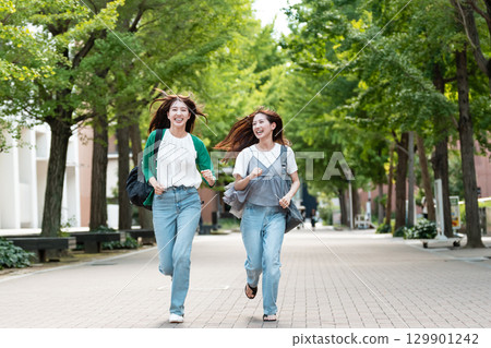 University campus female college student running 129901242