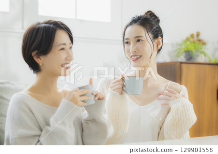 Woman drinking hot coffee in her room Woman drinking hot coffee in her room 129901558