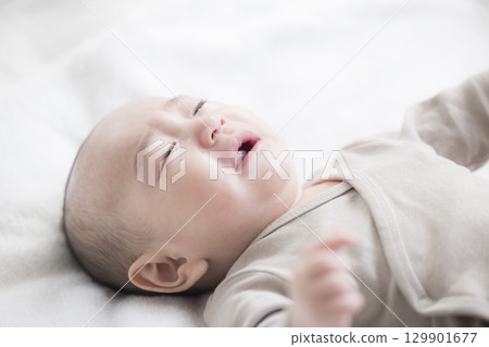 Young mother taking care of her baby Young mother taking care of her baby 129901677
