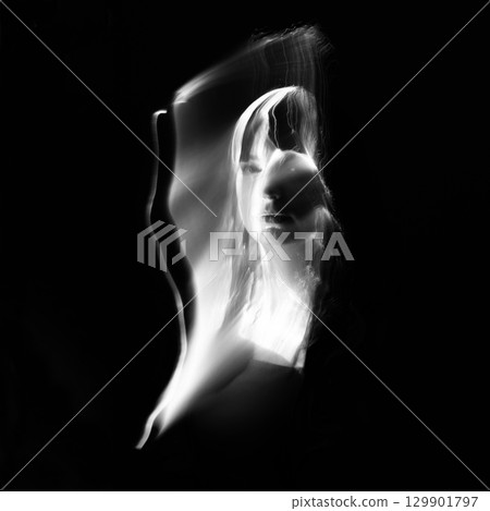 Abstract human silhouette in light trails of light painting 129901797