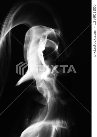 Abstract human silhouette in light trails of light painting Abstract human silhouette in light trails of light painting 129901800