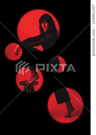 Woman portrait with dark hairs and clothes with one leg on chair 129902107