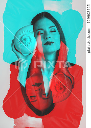 Woman listen sea rustle in seashell near her ear with closed eyes 129902525