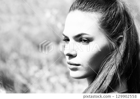 Close-up beautiful woman profile outdoor portrait in nature background Close-up beautiful woman profile outdoor portrait in nature background 129902558
