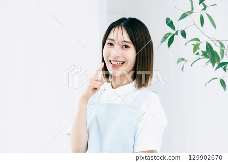 Female dental staff pointing at tooth 129902670