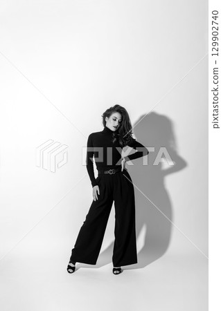 Woman with black outfit studio portrait on white background Woman with black outfit studio portrait on white background 129902740
