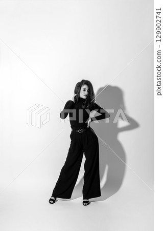 Woman with black outfit studio portrait on white background 129902741