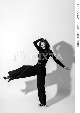 Woman with black outfit studio portrait on white background Woman with black outfit studio portrait on white background 129902743