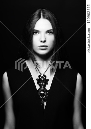 Beautiful woman with fancy necklace studio portrait 129902835