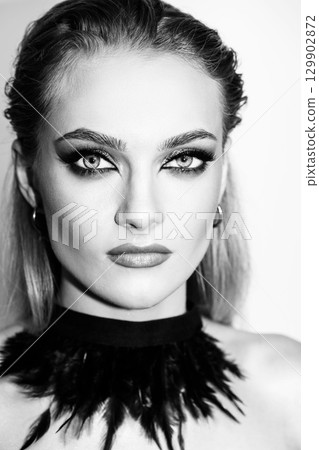 Beautiful woman with smokey makeup close up studio portrait 129902872