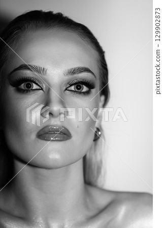 Beautiful woman with smokey makeup close up studio portrait 129902873