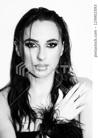 Beautiful woman with smokey make-up and wet hair studio portrait Beautiful woman with smokey make-up and wet hair studio portrait 129902893