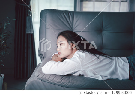 Sorrowful woman sat alone, overwhelmed by emotion, her sad and unhappy expression revealing deep despair, stress and distress left feeling depressed. sorrowful sad, despair alone, depressed stress Sorrowful woman sat alone, overwhelmed by emotion, her sad and unhappy expression revealing deep despair, stress and distress left feeling depressed. sorrowful sad, despair alone, depressed stress 129903006