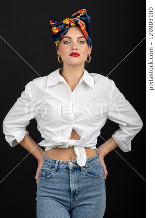 Woman with make-up and scarf on her head studio portrait 129903100