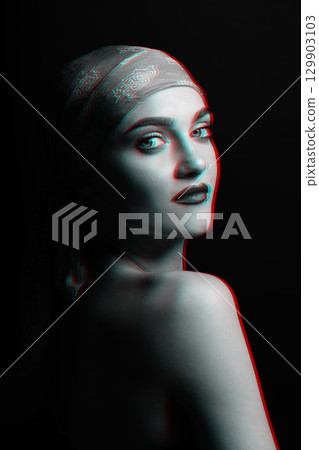 Woman with scarf on her studio portrait in RGB color split effect style 129903103