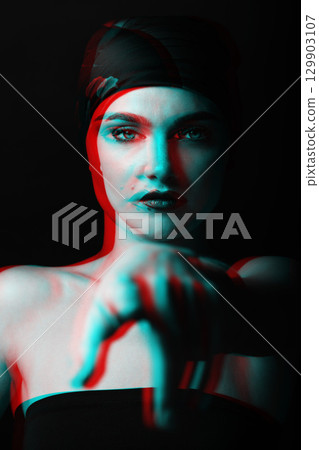 Studio portrait of beautiful woman with scarf on her head pointing finger to camera in RGB color split effect Studio portrait of beautiful woman with scarf on her head pointing finger to camera in RGB color split effect 129903107