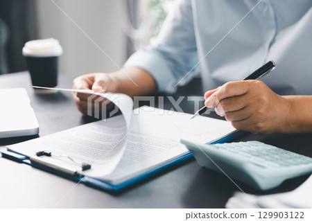 Business person with contract law and paper work for business finance, loan application form, contract real estate and insurance concept. signing contract, working on desk, business document 129903122