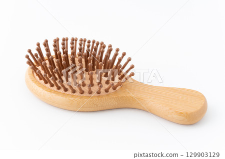 Bamboo hairbrush on white background 129903129
