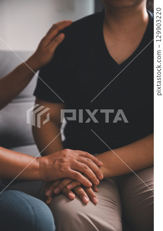 Hope and trust with crisis concept. Closeup, love and holding hands for support, comfort and care with grief, loss and empathy. people and family with compassion, sympathy and healing with bonding. Hope and trust with crisis concept. Closeup, love and holding hands for support, comfort and care with grief, loss and empathy. people and family with compassion, sympathy and healing with bonding. 129903220