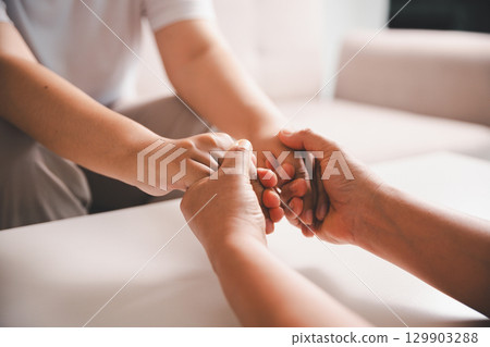 Hope and trust with crisis concept. Closeup, love and holding hands for support, comfort and care with grief, loss and empathy. people and family with compassion, sympathy and healing with bonding. 129903288