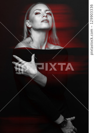 Beautiful woman with black dress studio portrait in RGB color split effect style 129903336