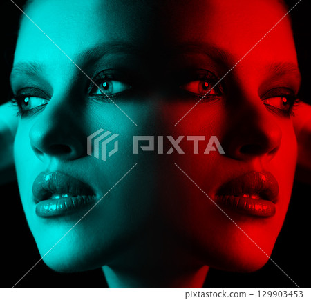 Close-up studio portrait of beautiful woman with fancy make-up in RGB color split effect style 129903453