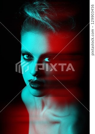 Beautiful woman with fancy make-up close-up studio portrait in RGB color split effect style 129903456