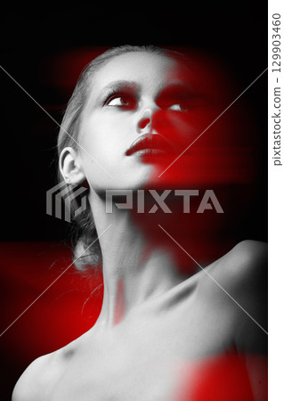 Beautiful woman with fancy make-up close-up studio portrait in RGB color split effect style 129903460