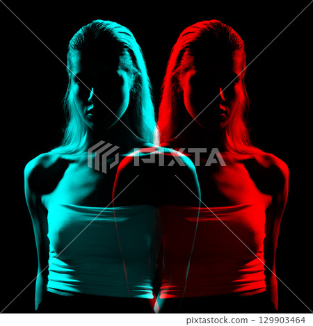 Studio portrait of woman silhouette partly illuminated with light in RGB color split effect style 129903464