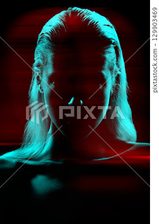 Studio portrait of woman silhouette partly illuminated with light in RGB color split effect style Studio portrait of woman silhouette partly illuminated with light in RGB color split effect style 129903469